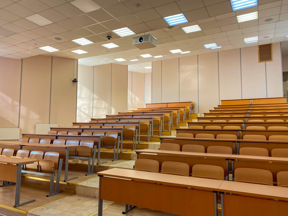 Empty lecture hall with tiered seating.